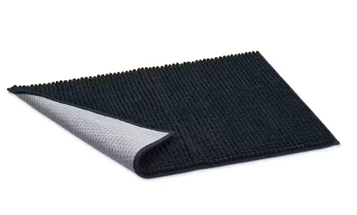 HUNTER Waterloo matta antracit 80x60 med ett uppvikt hörn som visar den gråa halkfria undersidan.