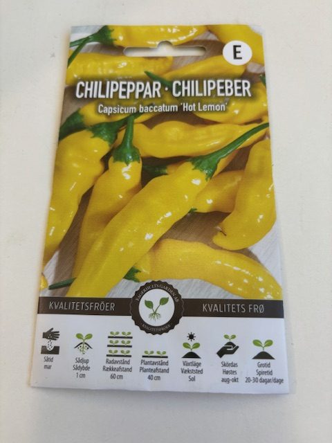 Förpackning med Chilipeppar 'Hot lemon' frön märkt Capsicum baccatum på vit bakgrund.