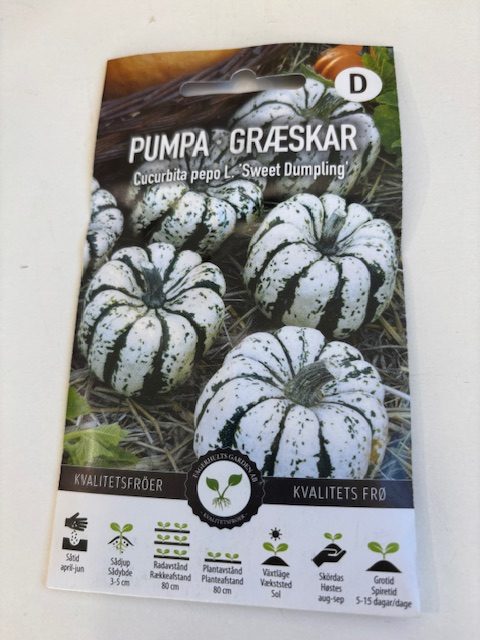 Paket med Pumpa 'Sweet dumpling' frön med bilder av små vita och grönrandiga pumpor.