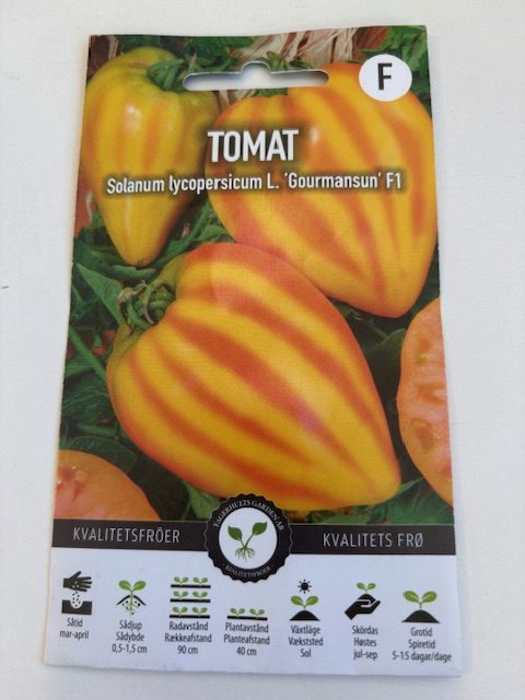 Paket med Tomat ´Gourmansun´F1-frön med bilder av gula och orange randiga tomater.