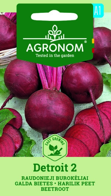 Flera runda, röda rödbetor 'Detroit 2' med gröna toppar på en grön och blå fröpåse.