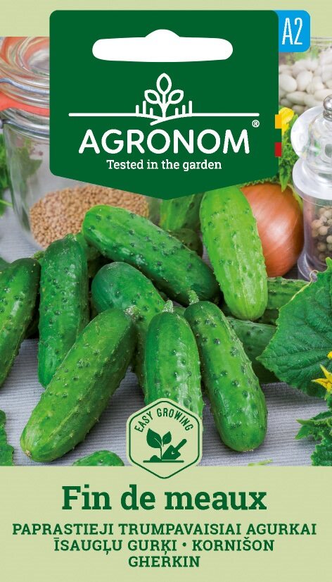 Flera färska gröna gurkor, Fin De Meaux med AGRONOM-fröförpackningar.