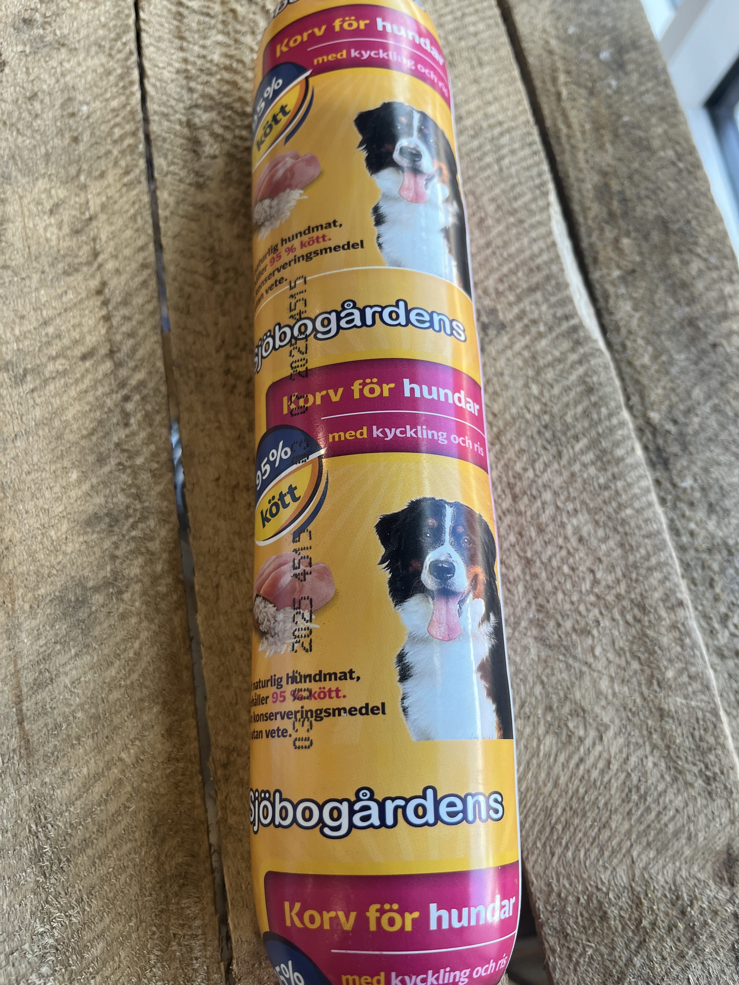 Hundmat Köttkorv Kyckling 10000g i en gul korvformad förpackning med en svartvit hund.