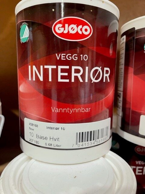 En röd burk Intergör 10 vit 0,68LITER interiörfärg på en hylla.