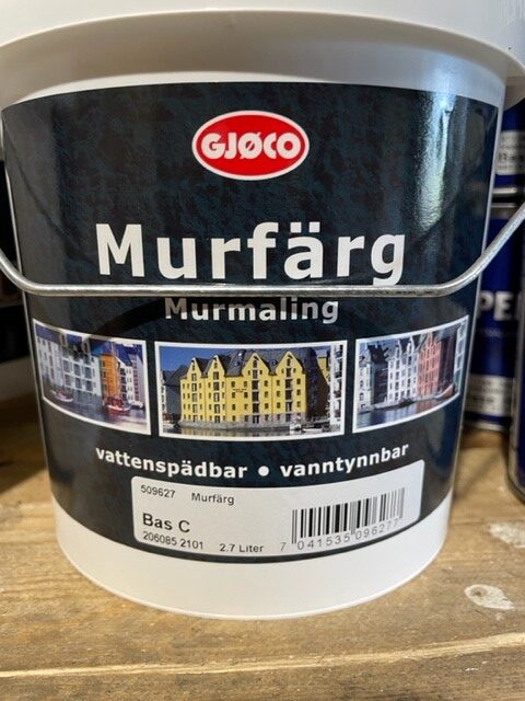 En 2,7L Murfärg bas svart färghink med färgglada byggnader på frontetiketten.